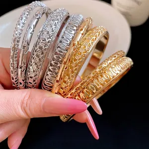 Elegant set of stacked geometric metal bangle bracelets with gold and silver finishes