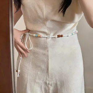 Bohemian waist chain detail with colorful wooden beads and white woven rope cord