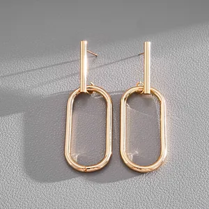 Detailed view of elegant gold-toned geometric oval link earrings with polished metal finish