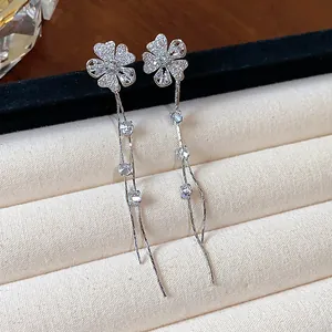 Detailed close-up view of silver flower tassel earrings featuring sparkling white zircon stones