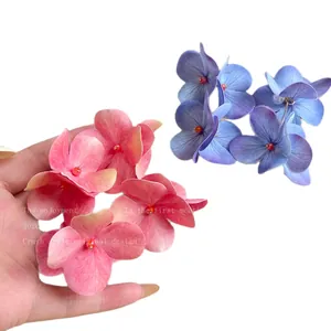 Handcrafted hydrangea flower stud earrings in pink and blue with delicate pearl accents