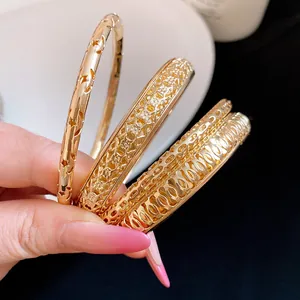 Set of three gold-tone geometric hollow-out bangles with star and lattice patterns
