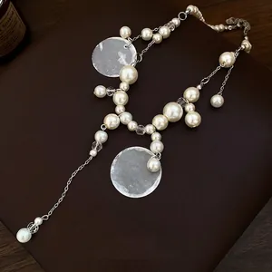 Elegant romantic pearl and shell beaded tassel necklace for a bohemian vacation look