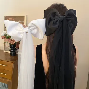 Macro view of sweet black and white mesh tassel fabric bow hair clips for women