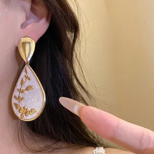 Vintage palace style water drop pendant earrings with gold floral print and white enamel