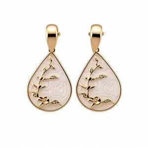 Elegant gold-toned water drop earrings featuring white floral enamel and silver needle studs