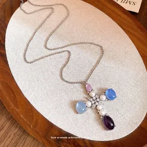 Elegant cross pendant necklace with colorful resin stones, pearls and zircons on a link chain.