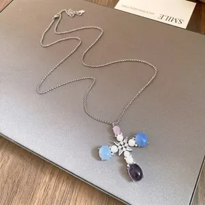 Elegant cross pendant necklace with pearls and colorful resin stones on a silver chain