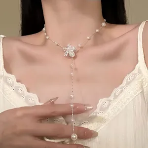 Detailed view of an elegant pearl flower adjustable clavicle necklace worn by a model
