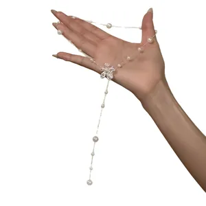 Elegant Korean style pearl flower necklace with adjustable silver chain shown on hand model