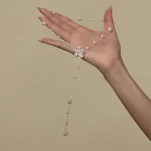 Elegant detail of silver flower pendant and pearls on adjustable lariat necklace