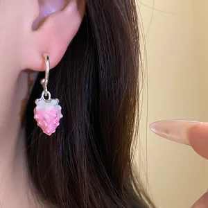 Close-up detail of a pink gradient strawberry pendant earring with silver hoop