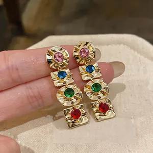 Vintage gold geometric dangle earrings featuring multi-colored rhinestones and crystals