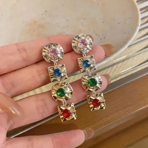 Vintage style gold-toned drop earrings featuring four multi-colored geometric crystal gemstones