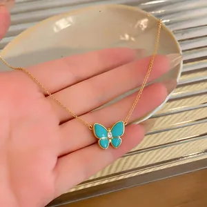Elegant turquoise resin butterfly necklace with a zircon centerpiece in a gold finish.