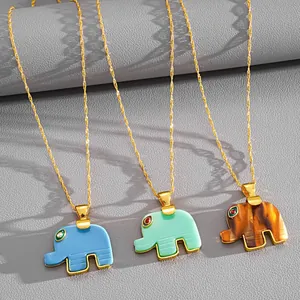 Detail view of colorful resin elephant pendant necklaces in blue, green, and brown shades