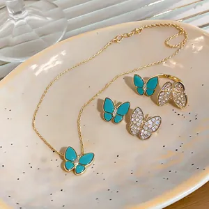 Detailed view of luxury butterfly jewelry set featuring teal resin and sparkling zircons
