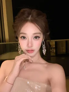 Detailed view of silver zircon tassel earrings worn by a model in a luxury setting.