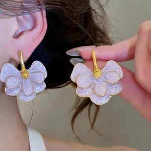 Elegant purple floral enamel stud earrings for a sweet and sophisticated style.