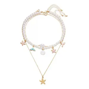 Detailed close-up of a multi-layered summer necklace with starfish and shell charms.