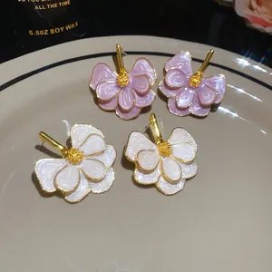 Elegant floral dripping oil stud earrings in white and pink, perfect for daily wear.