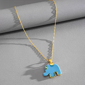 Detailed macro view of a cute blue resin elephant pendant on a gold necklace chain