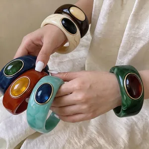 Exaggerated colorful marbled acrylic bangles with gold-rimmed resin stones for women