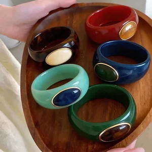 Statement colorful acrylic chunky bangles with resin oval inlay and gold-tone metallic frame