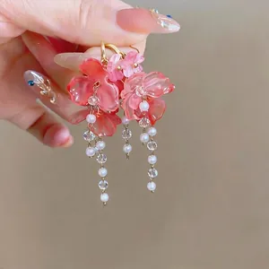 Elegant pink floral tassel earrings with faux pearls and crystals for a vacation look.