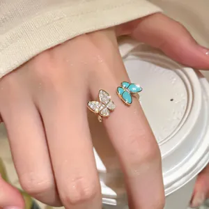 Macro detail view of elegant double butterfly open ring with zircon stones and turquoise resin