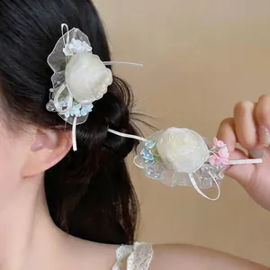 Close-up of elegant cream chiffon flower hair clips in a romantic French style