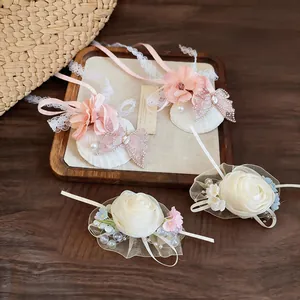 Detail view of elegant chiffon flower hair clips with lace ribbons and pearl accents.
