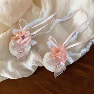 Close-up of elegant chiffon flower hair clips with delicate lace ribbons and butterfly motifs