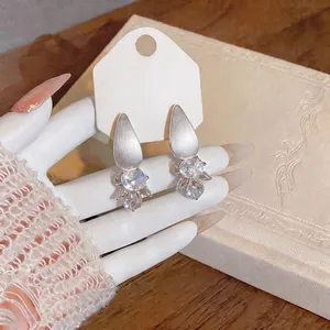 Elegant French style silver water drop earrings with clear zircon stones on white card