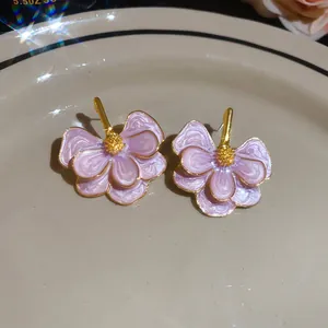 Detailed view of elegant light purple flower stud earrings with a gold finish