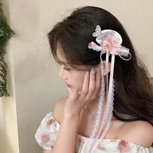 Elegant chiffon flower hair clip with butterfly and lace ribbon detail on model