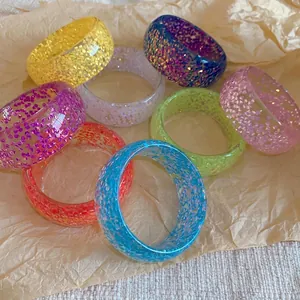 Collection of colorful glitter resin round bangles in vibrant dopamine shades for women