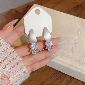 Detailed macro view of elegant silver waterdrop zircon stud earrings in French style
