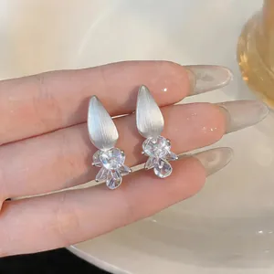 Close-up of elegant teardrop cubic zirconia stud earrings with matte silver finish