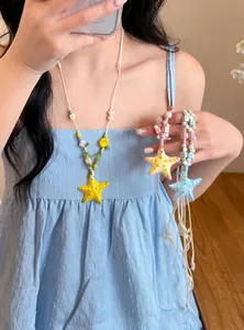 Detailed view of vibrant dopamine-style beaded necklaces with ceramic starfish pendants.