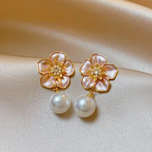 Close-up of elegant French retro flower drop earrings featuring pearls and zircon inlay