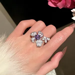 Close-up of heavy-duty purple zircon flower ring with adjustable band on hand