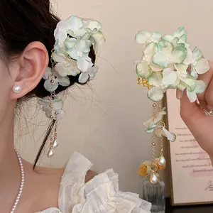 Detailed view of handmade fabric flower hair clip with elegant pearl tassels and chains