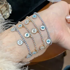 Close-up of 18k gold plated tennis bracelets with sparkling CZ evil eye charms