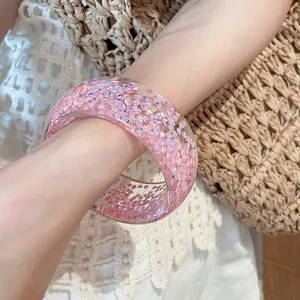 Close-up detail of a pink chunky resin bangle with sparkling iridescent glitter