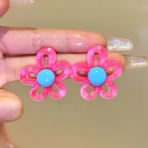 Sweet Korean style resin flower stud earrings in vibrant pink and blue colors.