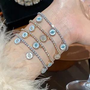 Detailed close-up of 18k gold plated evil eye bracelets with sparkly cubic zirconia dangles