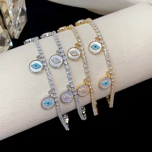 Close-up of 18k gold plated tennis bracelets with elegant Evil Eye charms and zircons