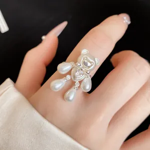Detailed macro view of an elegant bear-shaped ring featuring pearls and zircon heart.