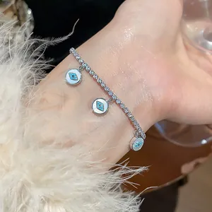 Detailed view of dainty 18k gold plated bracelet with cubic zirconia and evil eye charms